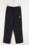 Black Adidas pants with a yellow logo on a white background