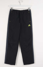 Black Adidas pants with a yellow logo on a white background