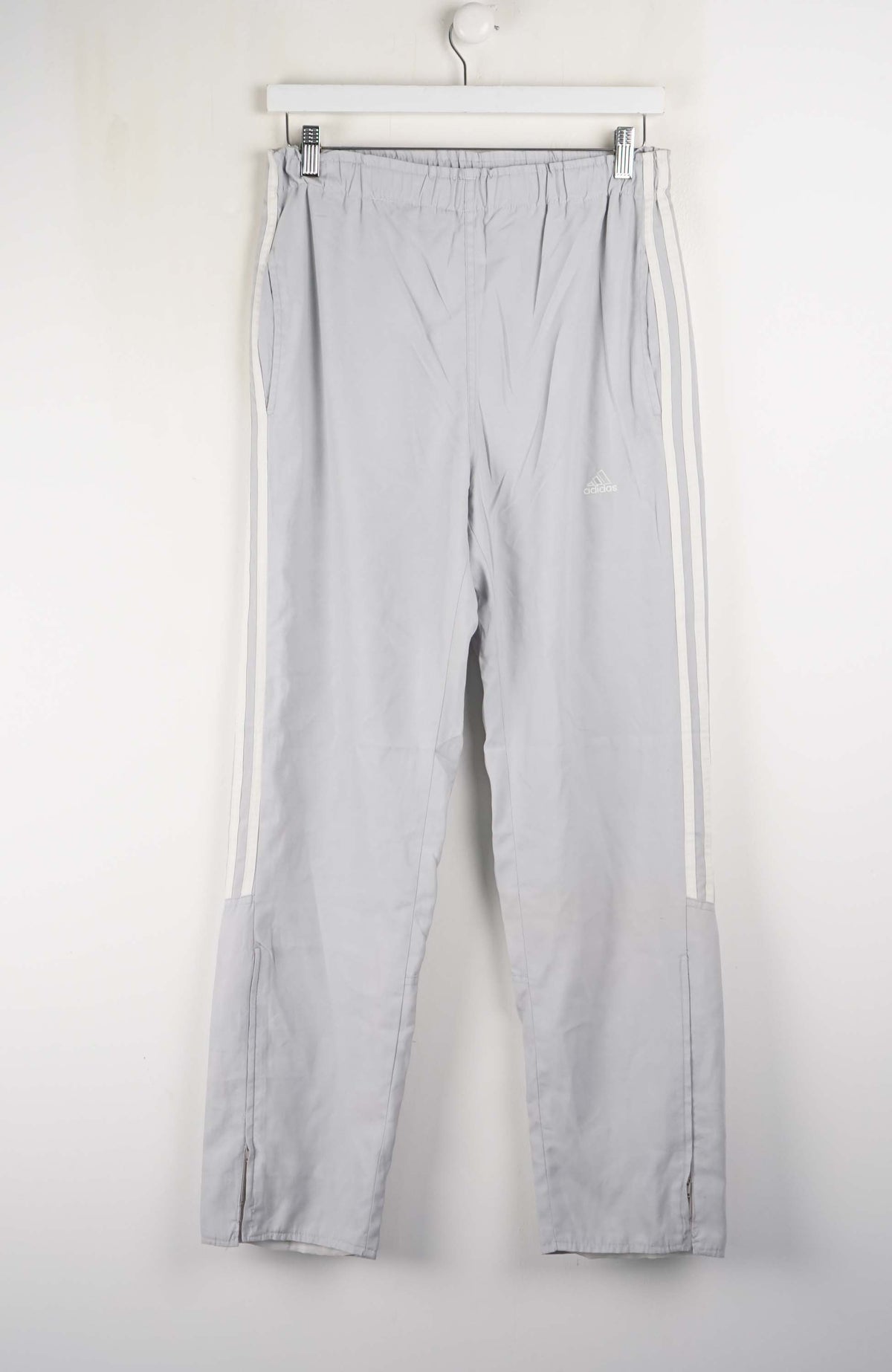 Light gray pants with white stripes on a white background