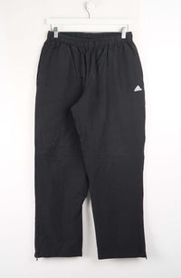 Black Adidas pants on a white background