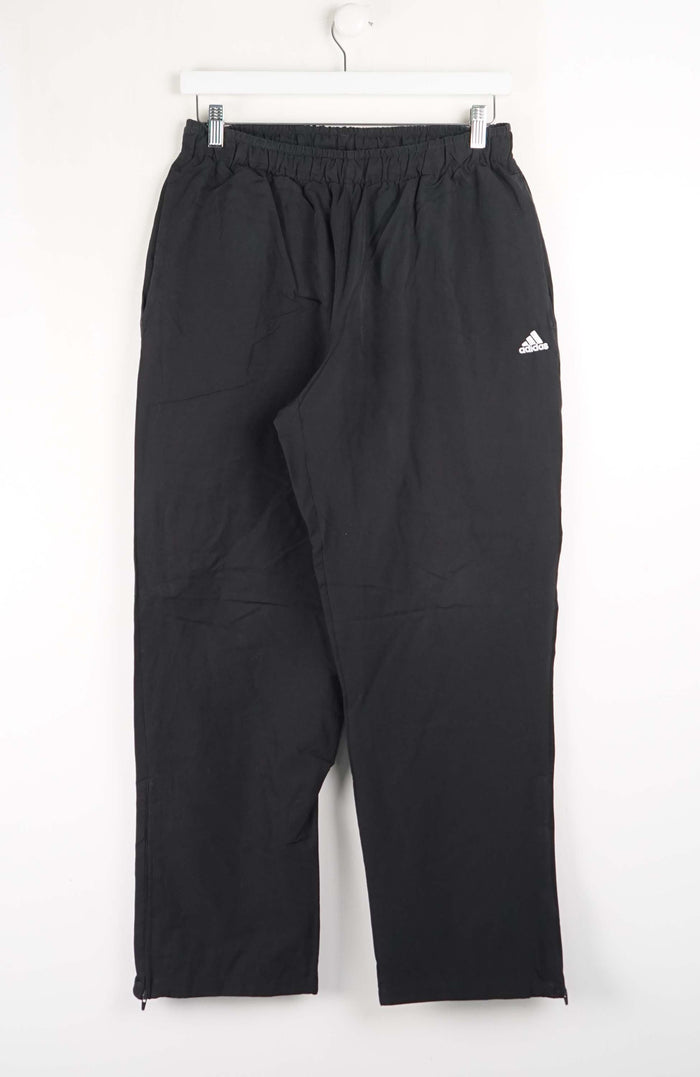 Black Adidas pants on a white background