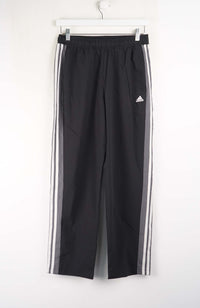Black Adidas pants with white stripes on a white background