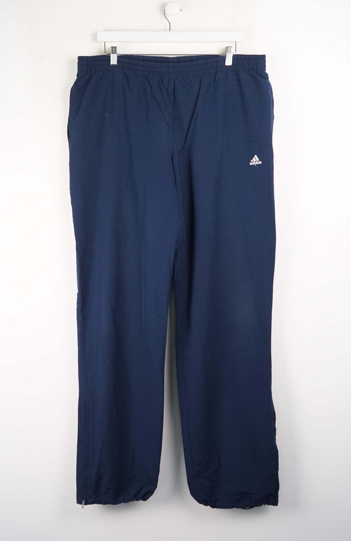 Navy blue pants with Adidas logo on a white background