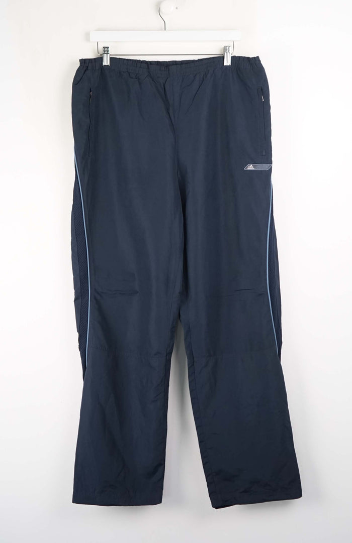 Navy blue pants with white label on a white background