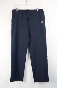 Navy blue pants with Adidas logo on a white background