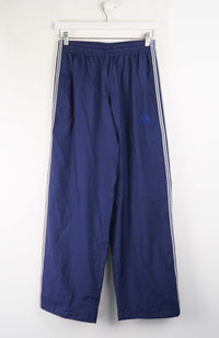 Blue track pants with white stripes on a white background