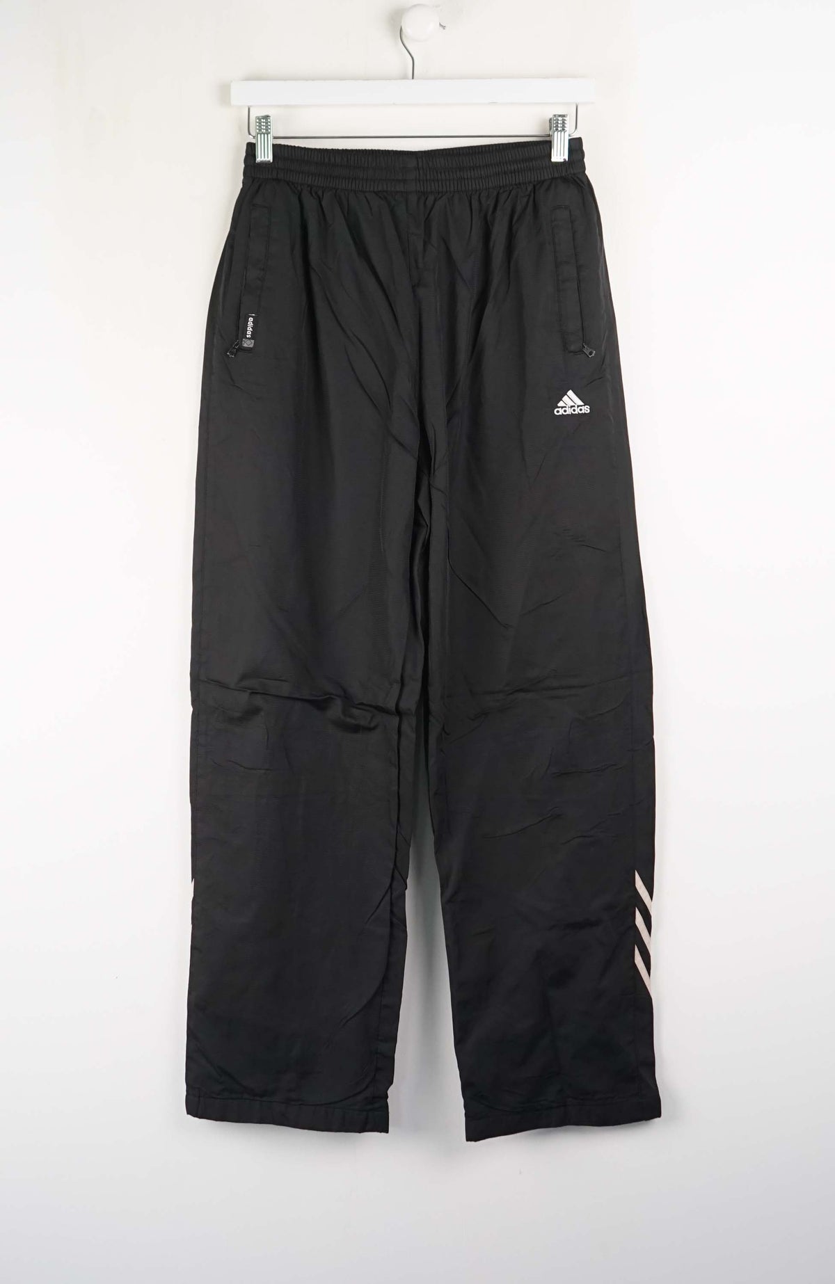 Black Adidas pants on a white background