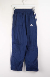 Blue Adidas pants with white stripes on a white background