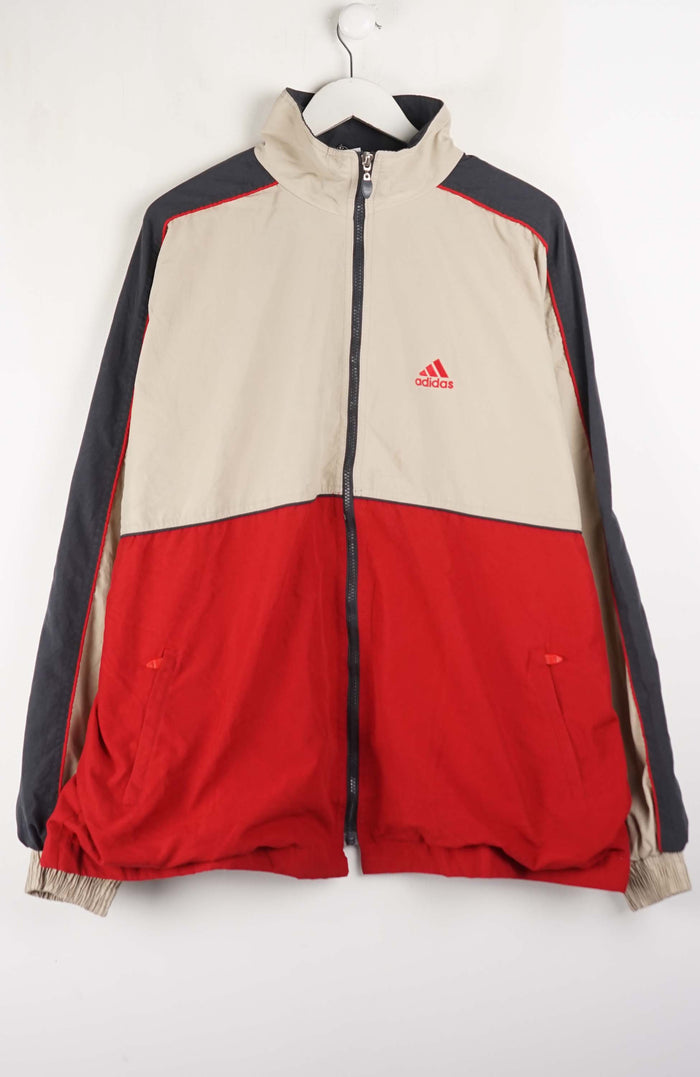 Two-tone red and beige jacket with Adidas logo on a white background