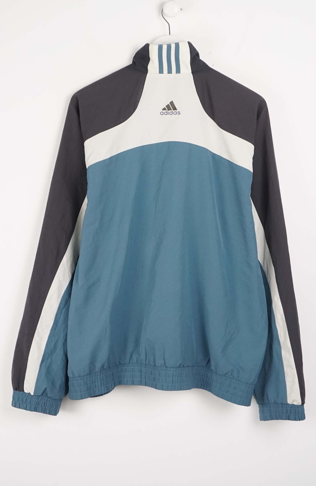 Color-blocked jacket with Adidas logo on a white background
