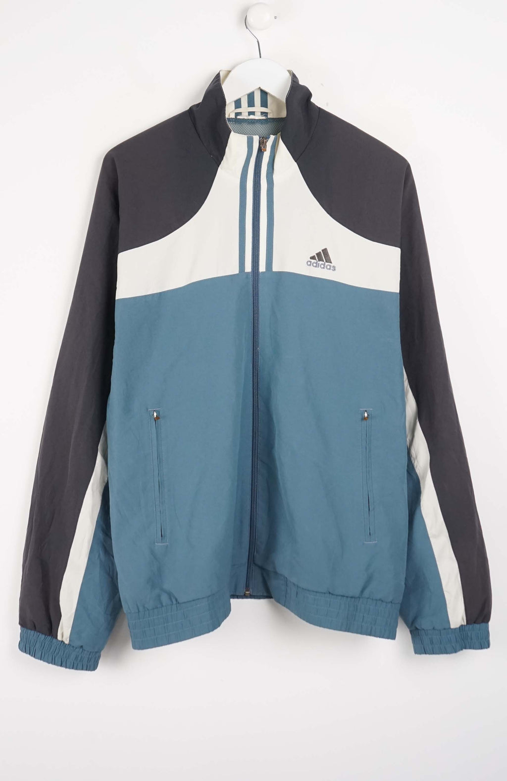 Color-blocked jacket with Adidas logo on a white background