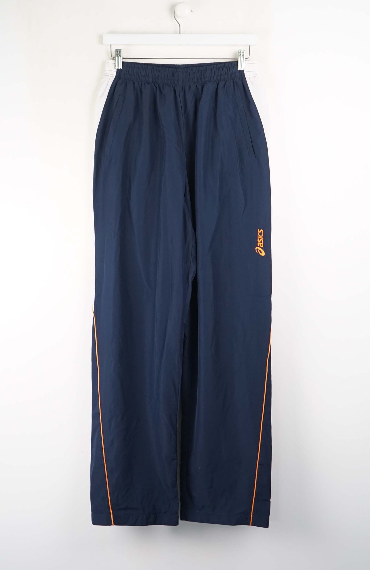 Navy blue pants with orange accents on a white background