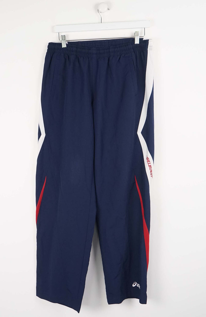Navy blue athletic pants with red accents and a logo on a white background