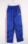 Blue track pants with red and white stripes on a white background