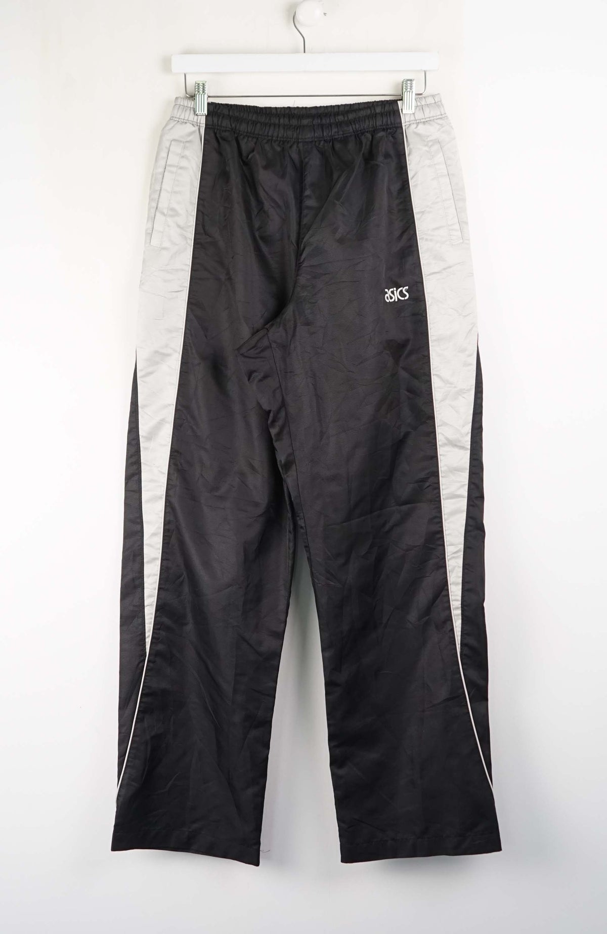 Black and gray track pants with a brand logo on a white background
