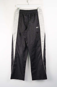 Black and gray track pants with a brand logo on a white background