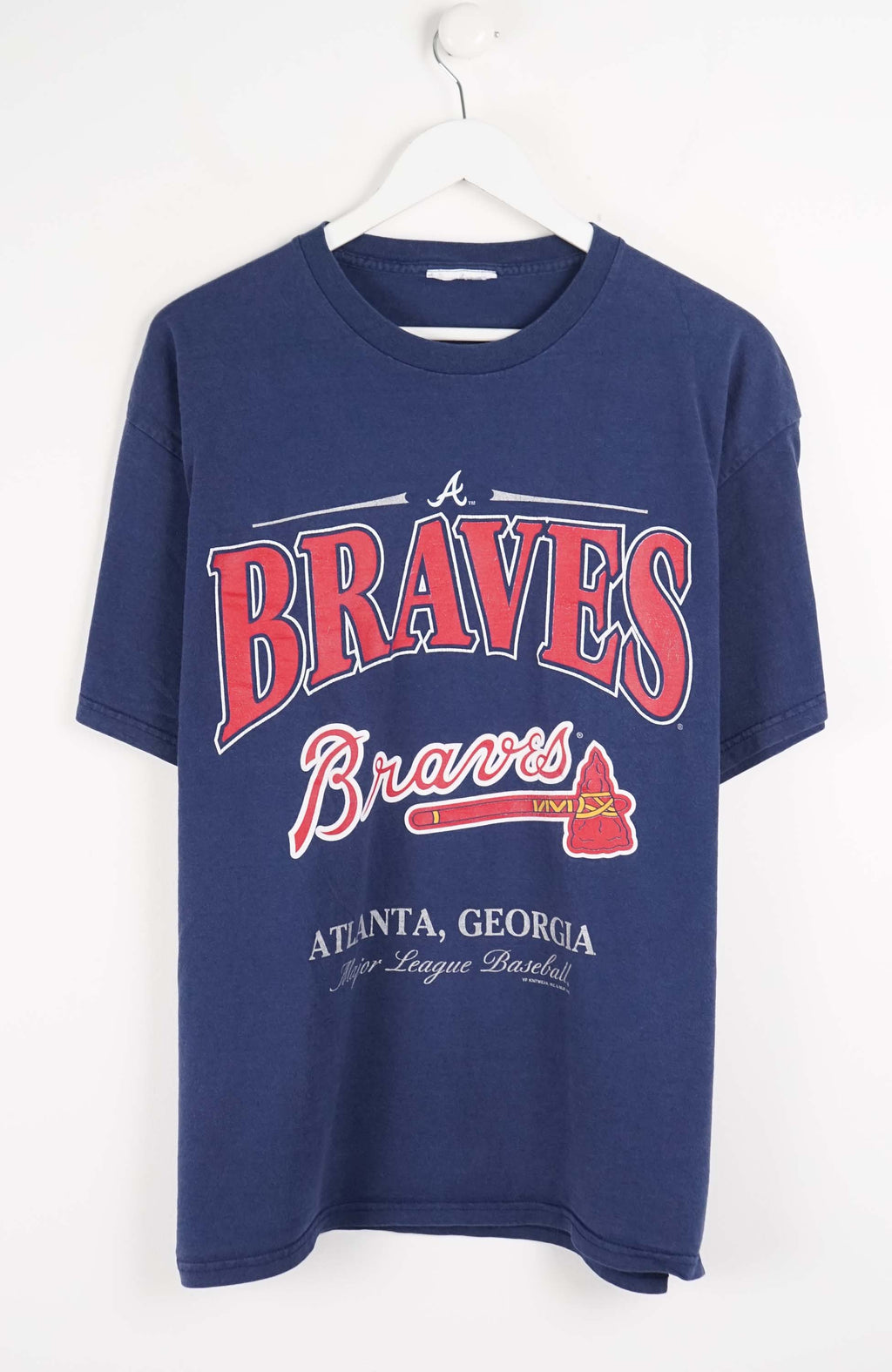 Blue t-shirt with 'Braves' logo on a white background