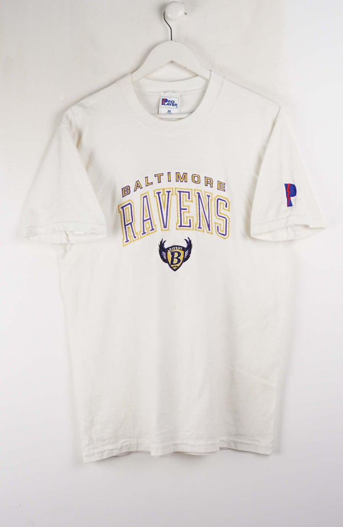 White long-sleeve shirt with Baltimore Ravens logo on a white background
