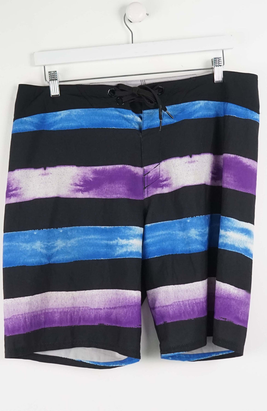 Striped shorts with black, blue, and purple pattern on a white background
