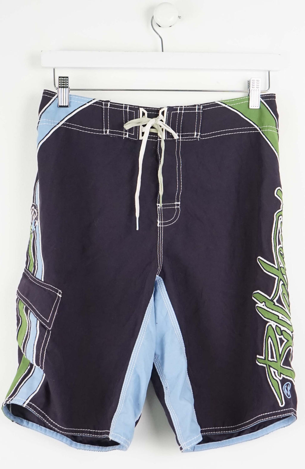 Black board shorts with blue and green accents on a white background