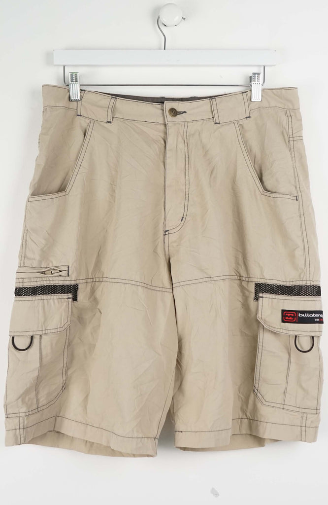 Beige cargo shorts with multiple pockets on a white background
