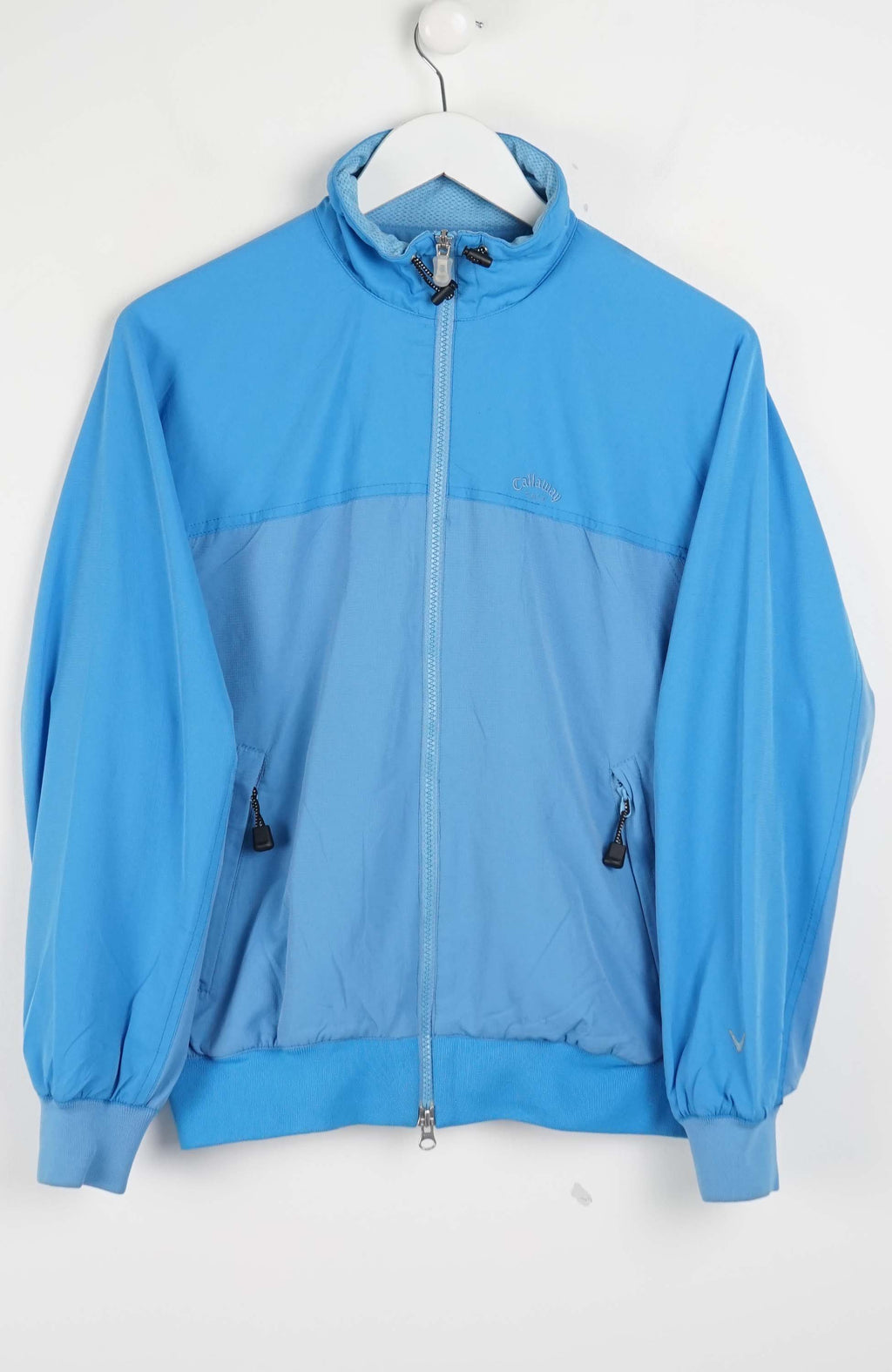 Blue jacket on a white hanger against a white background