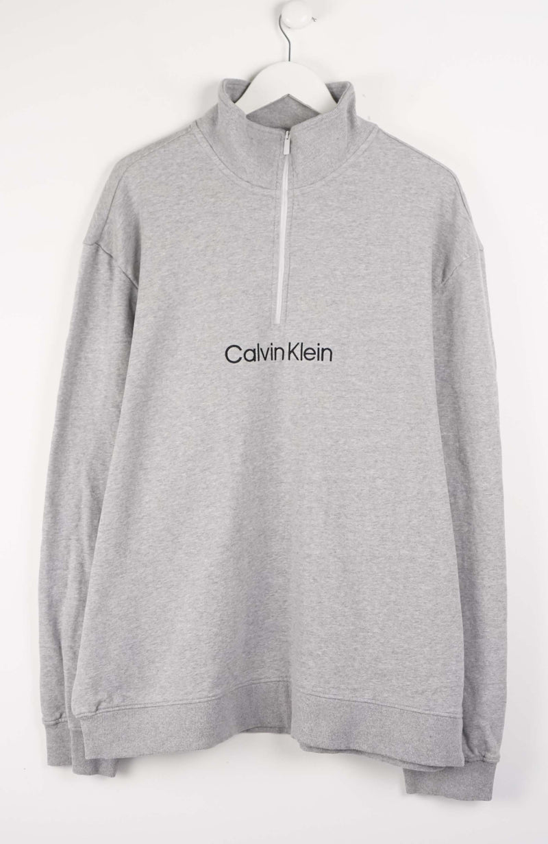 Gray Calvin Klein sweatshirt on a white hanger against a white background
