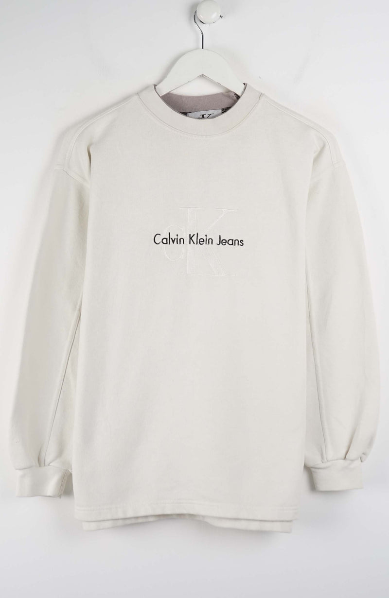 Beige sweatshirt with Calvin Klein Jeans logo on a white hanger