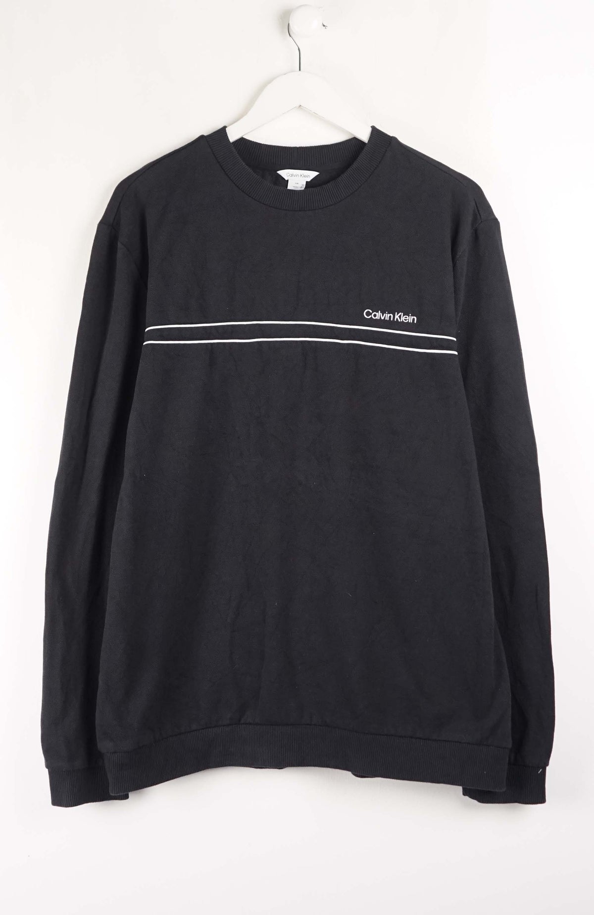 Black Calvin Klein sweatshirt with a white stripe on a white background