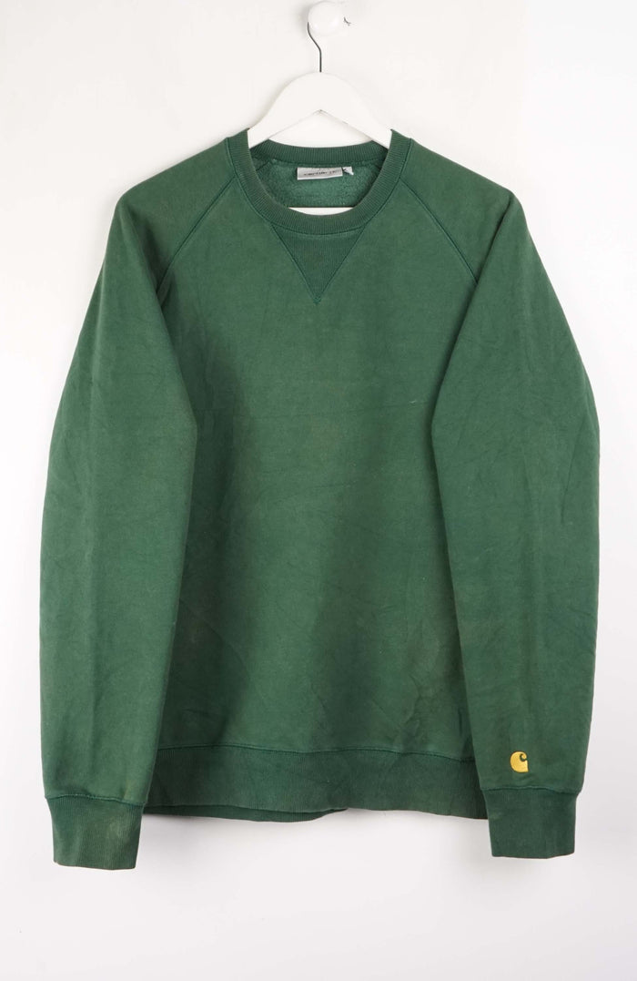 Green sweatshirt on a white hanger against a white background