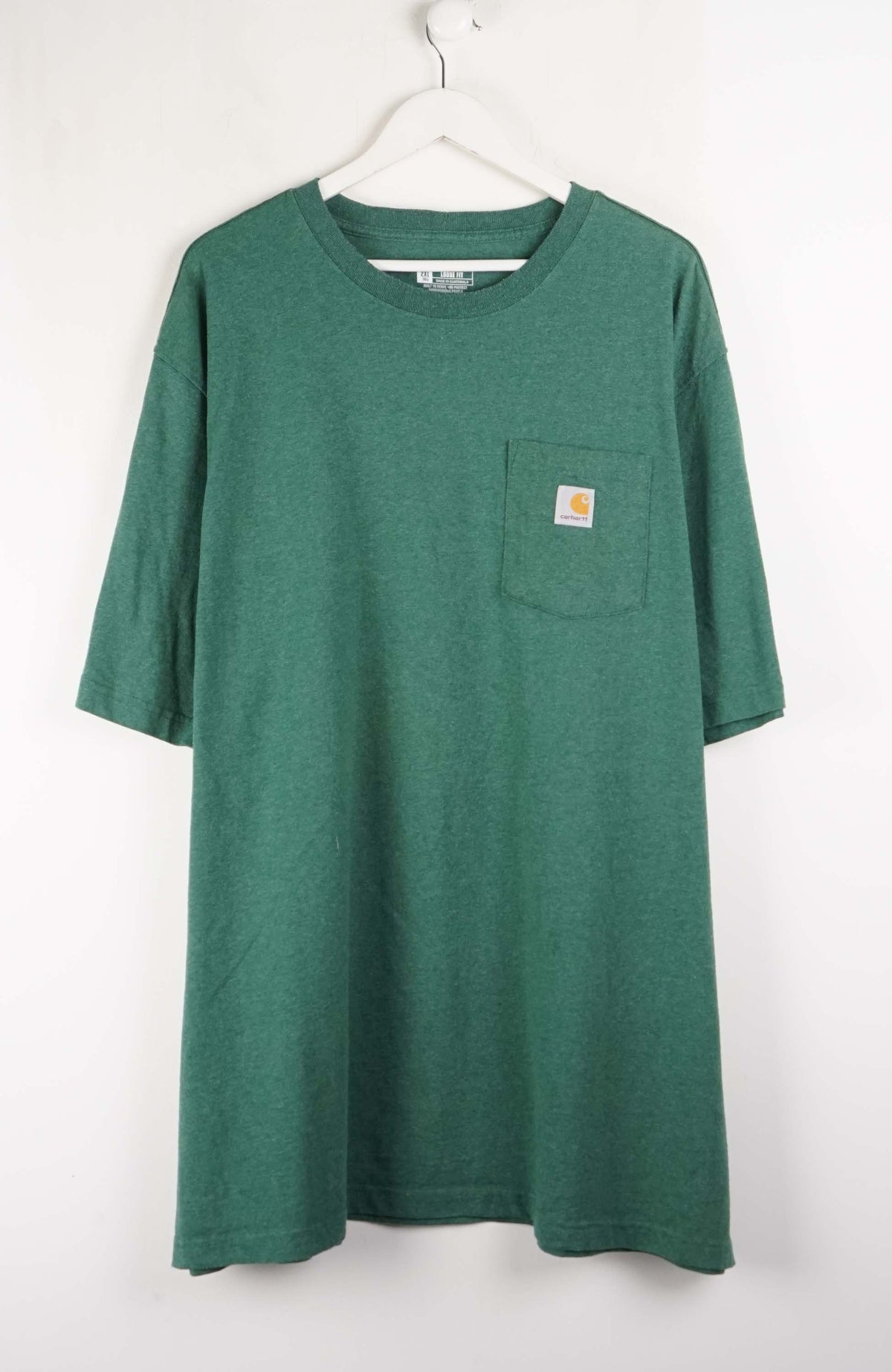 Green t-shirt with a pocket on a white background