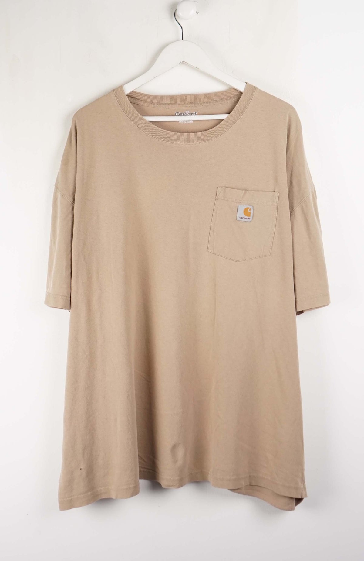 Beige long-sleeve shirt with a pocket on a white hanger against a white background