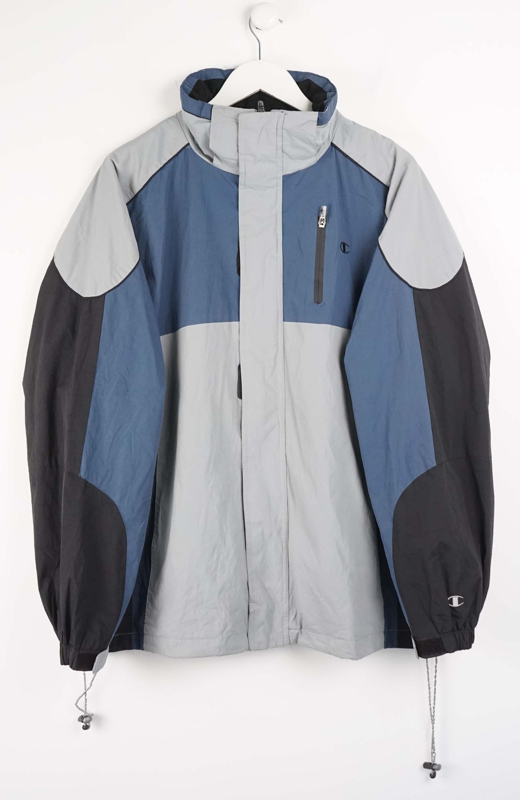 Multicolored jacket with blue, gray, and black sections on a white background