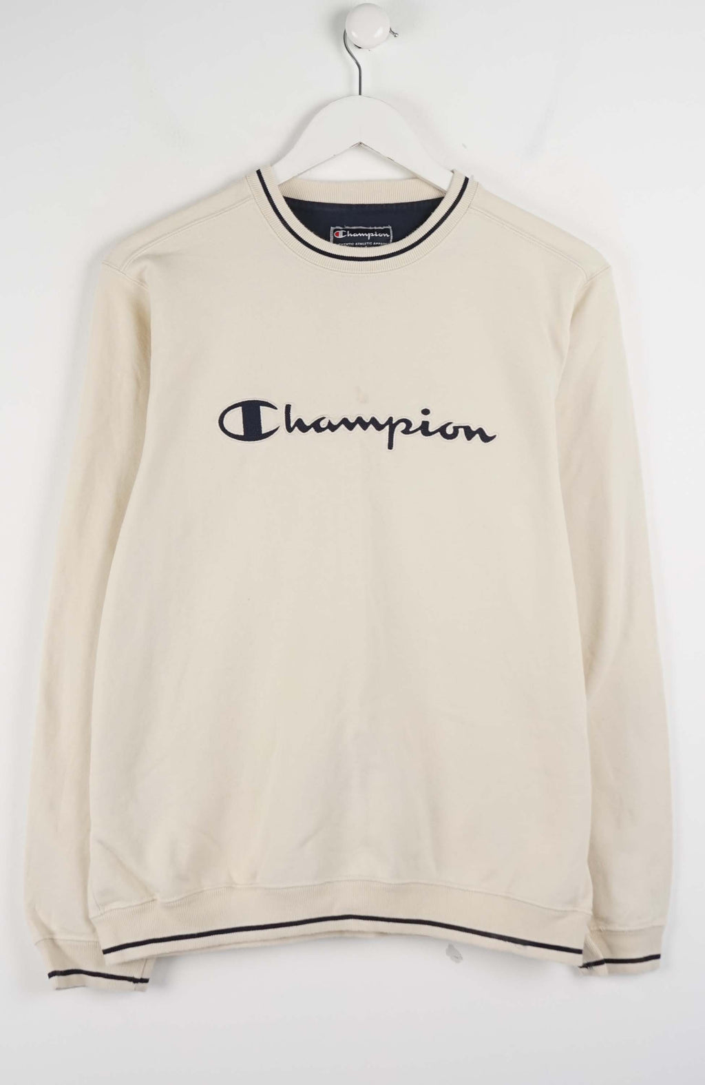 Beige sweatshirt with Champion logo on a white background