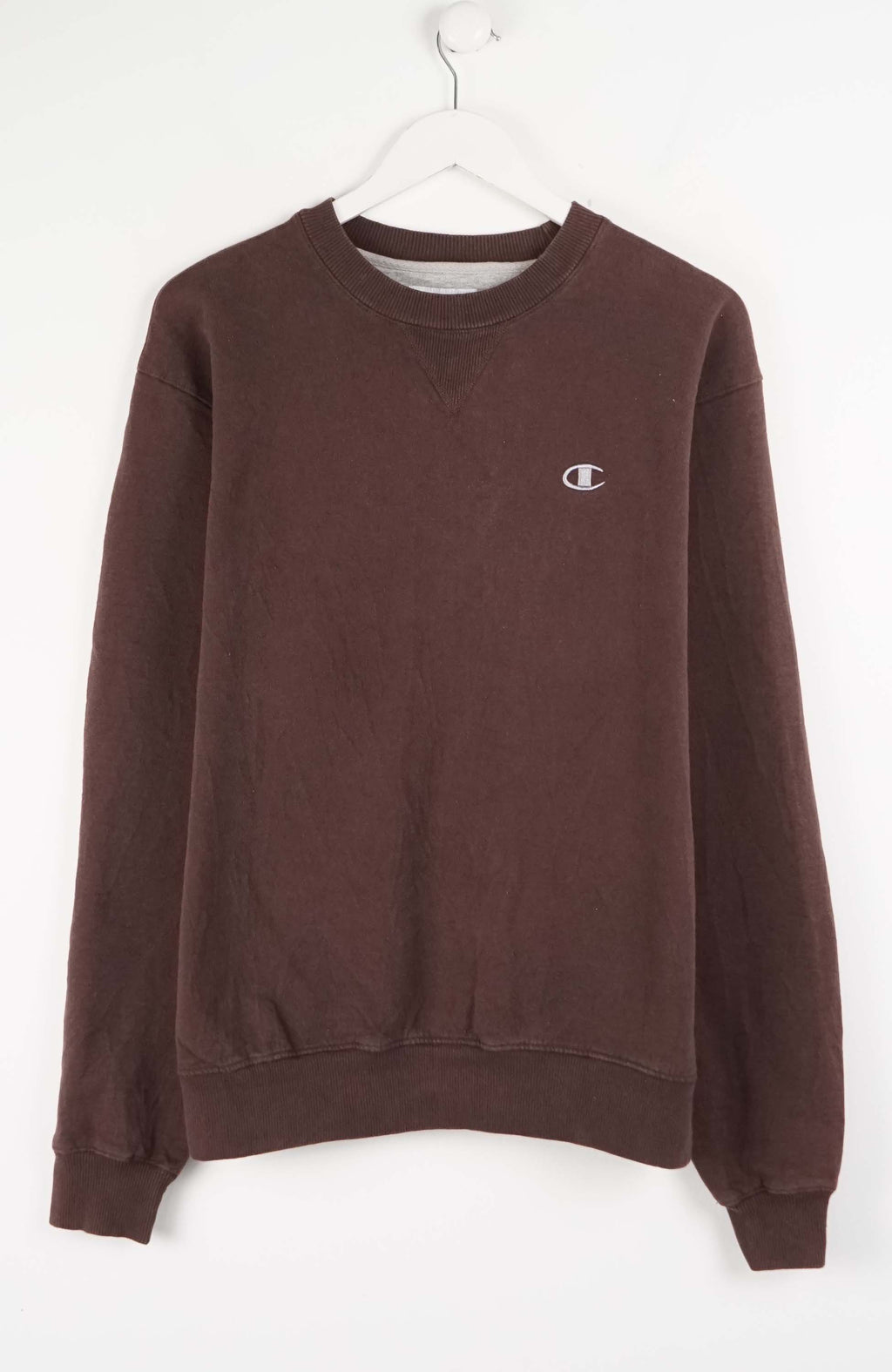 Brown sweatshirt with a small logo on a white background