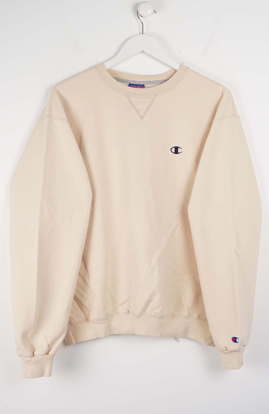 Beige sweatshirt with Champion logo on a white background