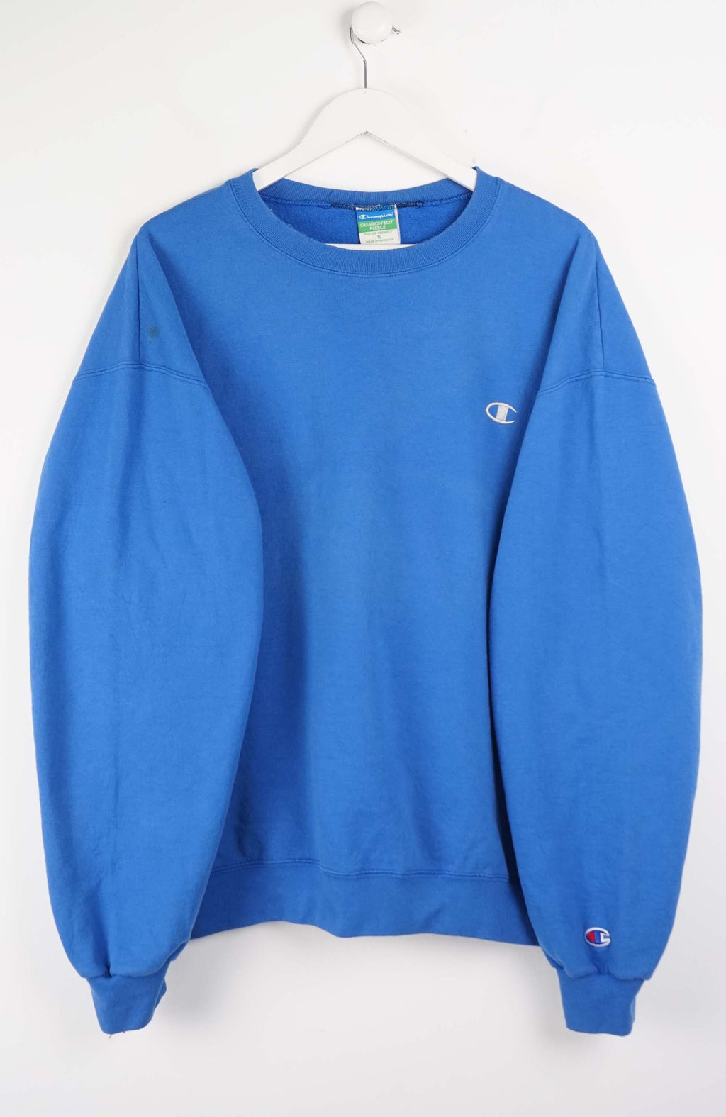 Blue sweatshirt with Champion logo on a white background
