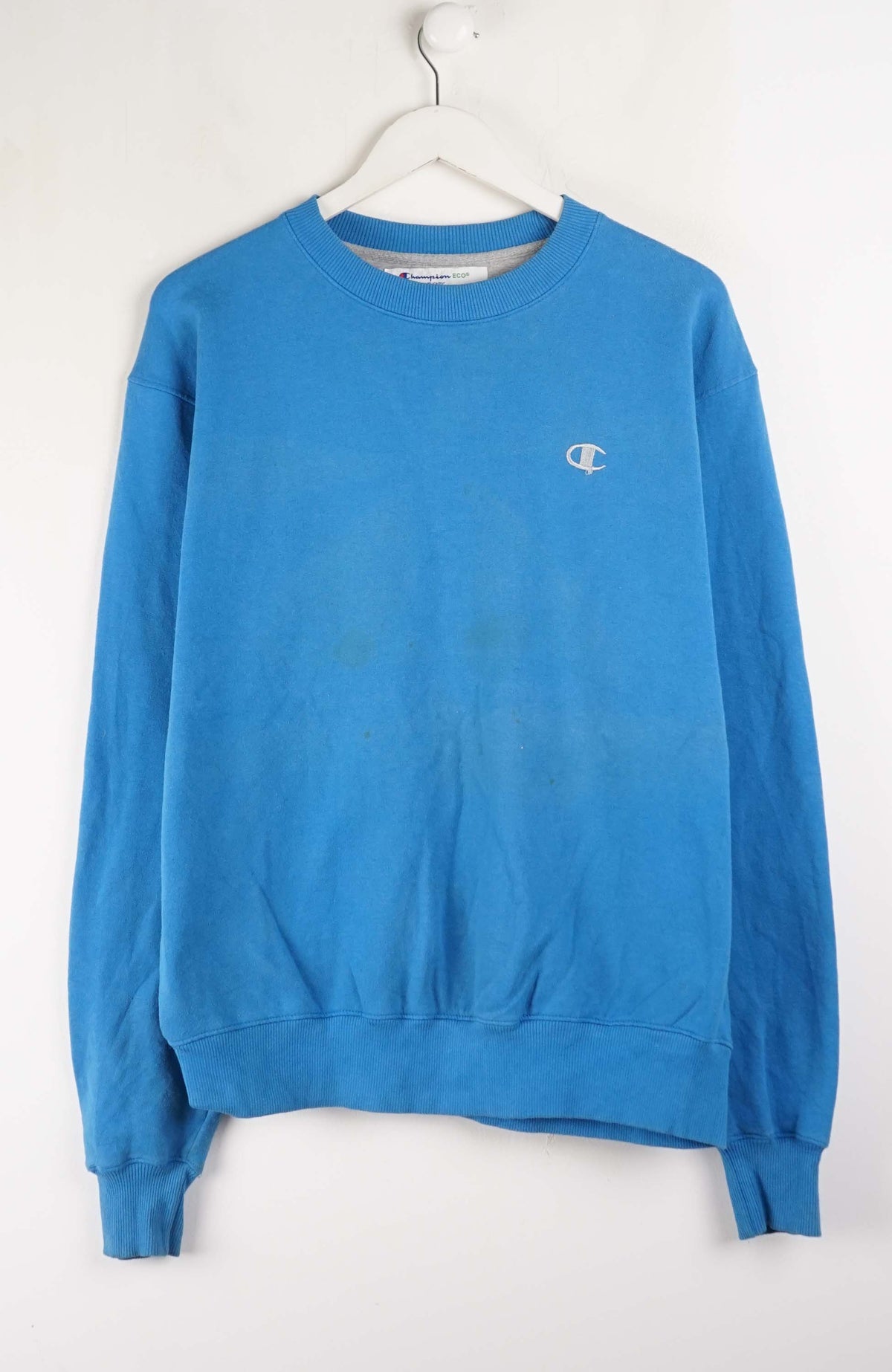 Blue sweatshirt with a small logo on a white background