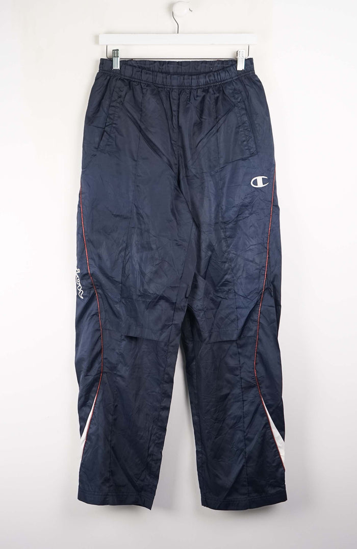 Navy blue pants with Champion logo on a white background