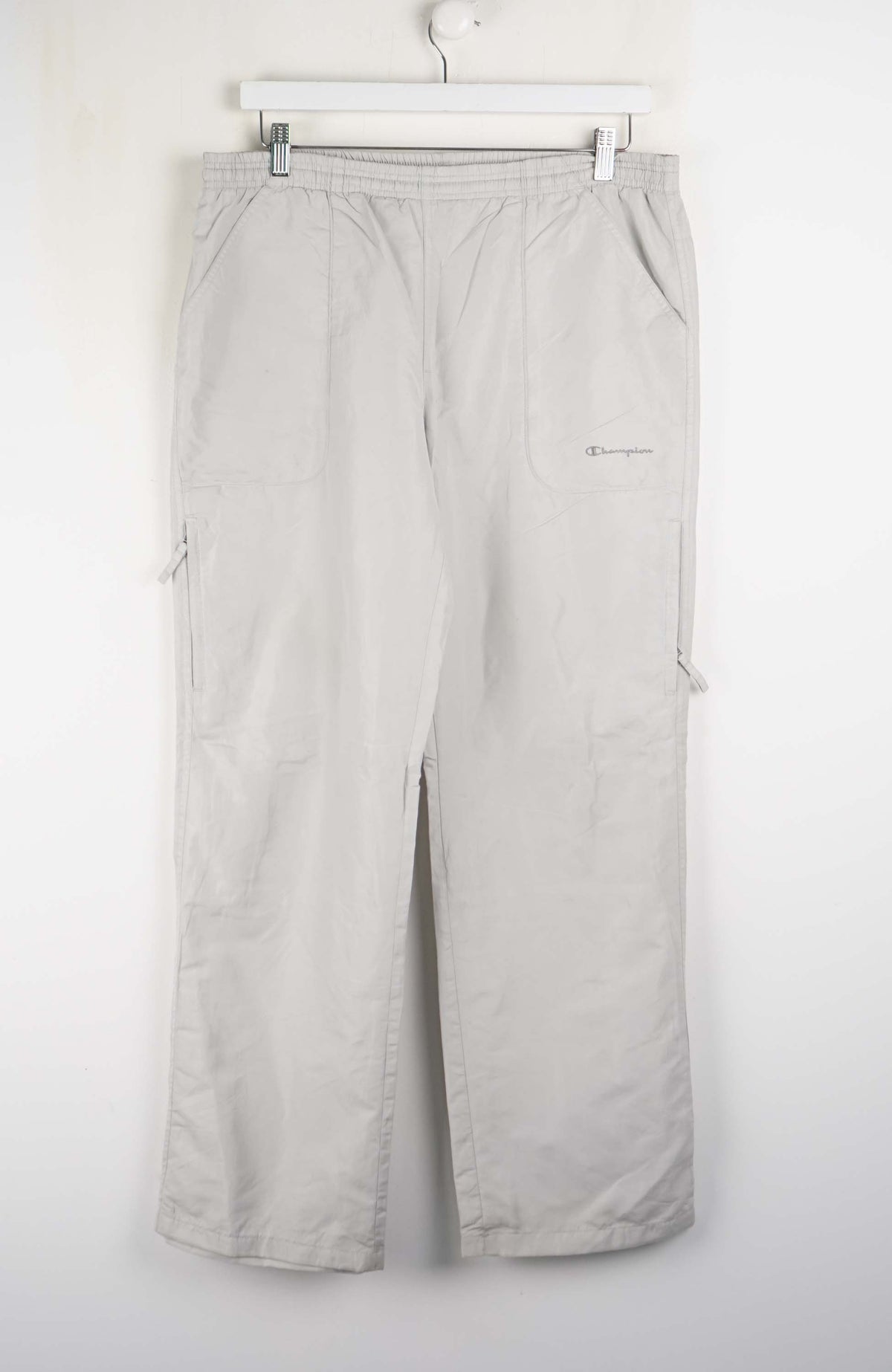 Light gray pants hanging on a white background