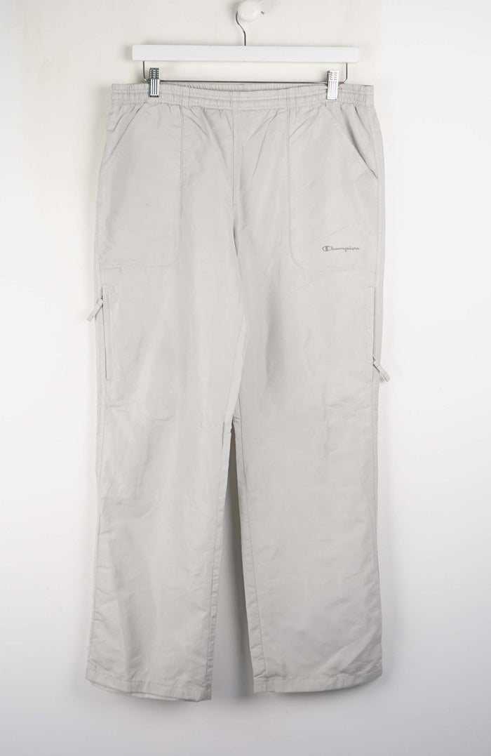 Light gray pants hanging on a white background