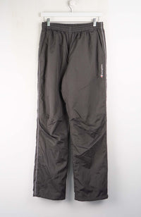 Dark gray pants hanging on a white wall
