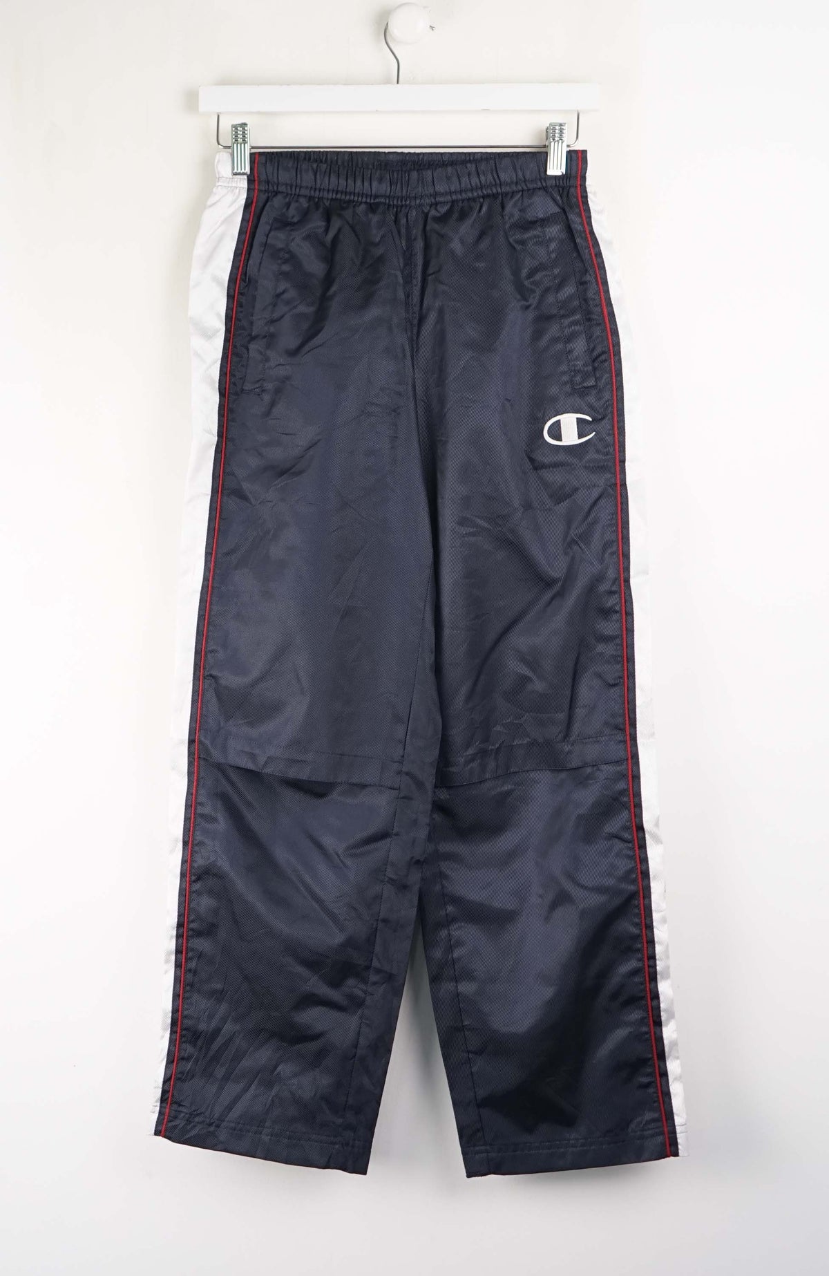 Navy blue pants with a brand logo on a white background