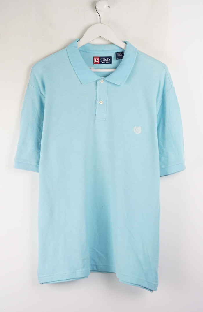 Light blue polo shirt on a hanger against a white background