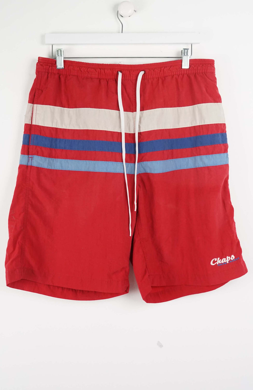 Red shorts with blue and gray stripes on a white background