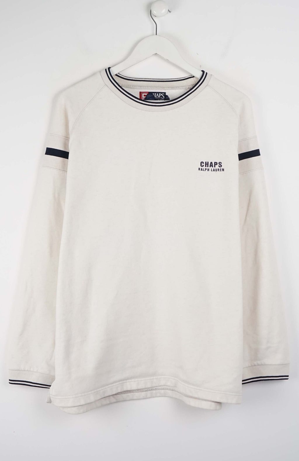 White long-sleeve shirt with black trim on a hanger against a white background