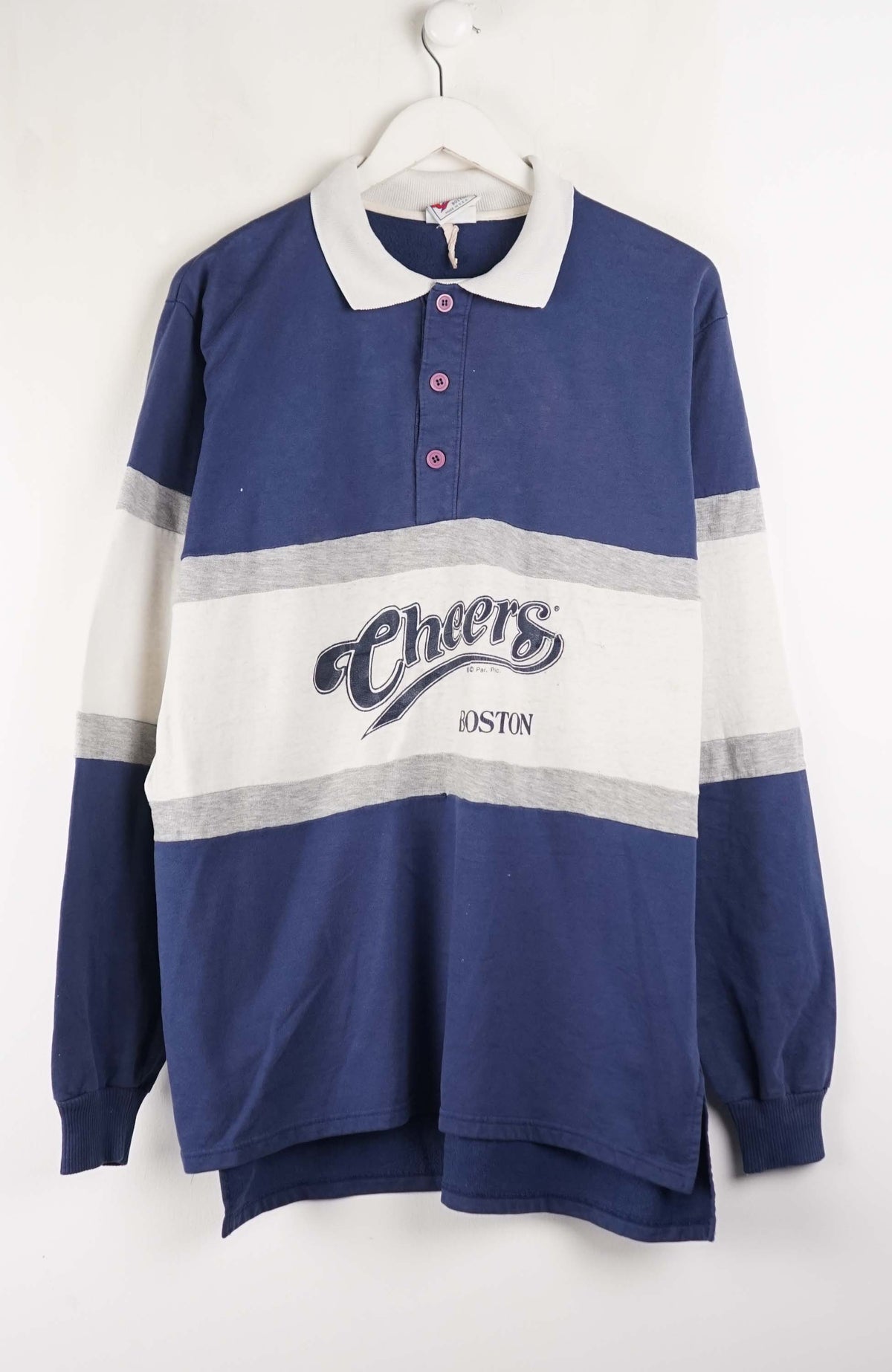 Blue and white striped sweater with 'Cheers' branding on a hanger against a white background