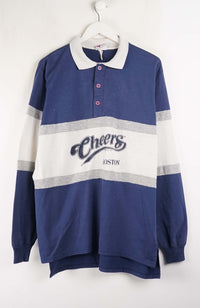 Blue and white striped sweater with 'Cheers' branding on a hanger against a white background