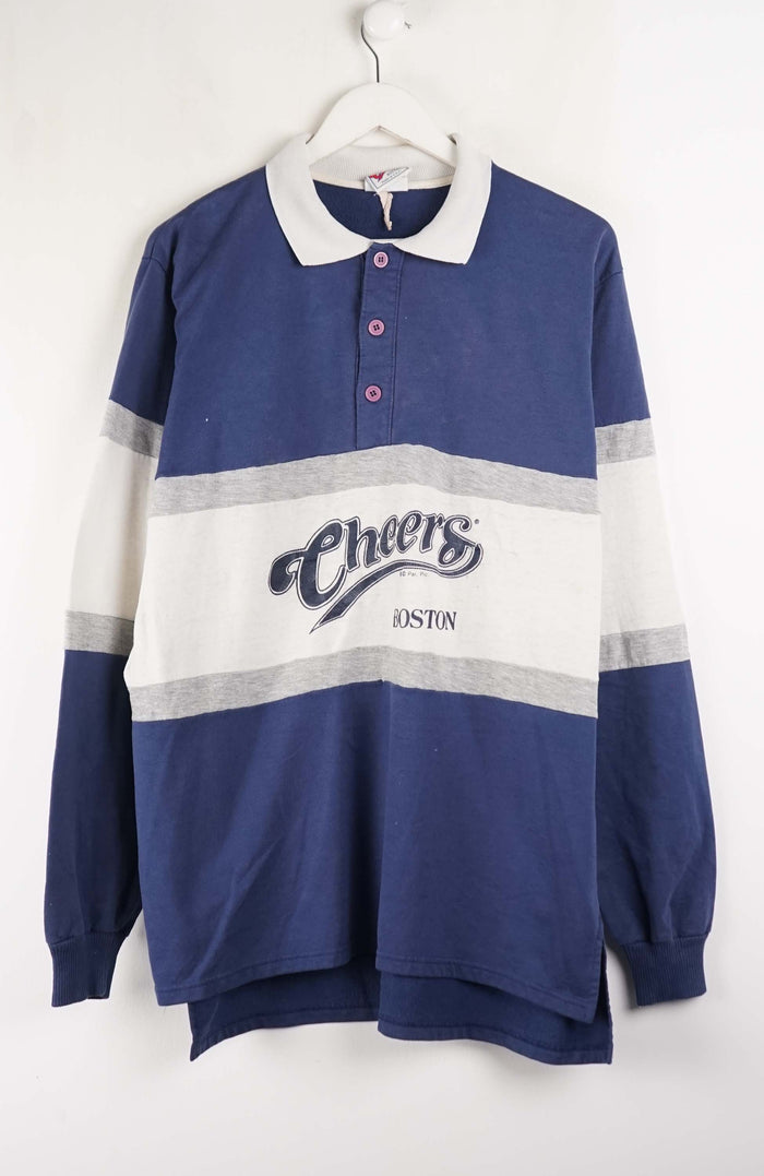 Blue and white striped sweater with 'Cheers' branding on a hanger against a white background