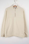 Beige fleece pullover on a hanger against a white background